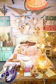 The girls upcycle a spanish ship lamp into a chandelier and an old spool into a table to decorate the space. Junk Gypsy