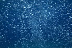 Underwater View Of Air Bubbles Rising Through Blue Ocean Water ...