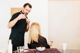 She and the other ladies are friendly and professional and really listen to what you want. A Hair Colourist Working With Foils To Give A Client With Long Blonde Hair Highlights And Lowlights Using Colour Stockphoto