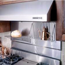 The heat resistant backsplash offers a unique natural texture that you cannot get notice how the rugged feature wall throws focus to the smooth stainless steel range and matching oven hood. Range Hoods Stainless Steel Backsplash With Shelves Available In Different Sizes By Broan Kitchensource Com