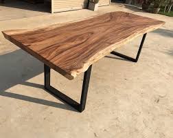 I love how this coffee table mixes black iron legs, a brass top, and raw wood edges for a perfect industrial trio, she shares. Pin On Wood Slab Dining