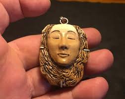 Amulet of the goddess of the earth Gaia. Made of buffalo bone, ebony wood  and silver