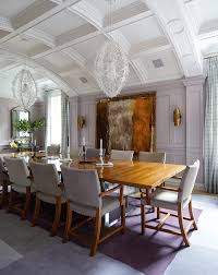 A beautiful shabby chic dining room with a crystal chandelier, white furniture, a ruffle tablecloth and blooms a neutral shabby chic dining room with white furniture, a vintage lamp, a large mirror and a faux fireplace and a lace tablecloth Romantic Dining Room Decor Royal City Realty