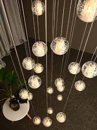 The frame is made out of metal, and it comes with a clear hanging bubble crystal. Crystal Bubbles Ball Chandelier Modern Hanging Glass Pendant Lights For Staircase Glass Pendant Light Modern Chandelier Chandelier Pendant Lights