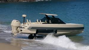 iguana s commuter amphibious yacht drives out of the sea onto the beach commuter amphibious yacht drives out