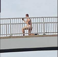 Drivers stunned as naked exerciser does lunges and squats on footbridge  over a busy road | The Sun