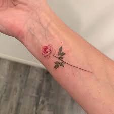 The pair of scissors and pink ribbon are a cute way to depict her profession. 23 Chic Small Rose Tattoos For Women Stayglam