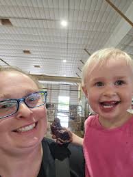 Adelaide had to have a chocolate donut last night while helping do chores  before dinner. Kristin stocked the stand this morning with The Farmer's Cow  milk and eggs! And this afternoon Crumby