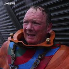 Veteran fundraiser Lloyd Scott has raised almost £50,000 for charity after  reaching the summit of Snowdon in a 130lb deep sea diving suit. This is the  moment he reached the top bit.ly/2ImqZ8W