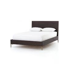 It stands on four tapered, wooden legs,. Wyeth Dark Wood Bed