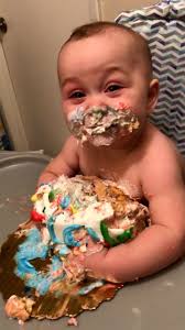 Little boy enjoys his first ever birthday cake