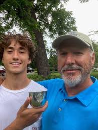 Congratulations to Randy Trost for receiving the Athletic Boosters'  Excellence Award for Cross Country. This award recognizes scholarship,  leadership, spirit and integrity. Randy is shown here with Coach Van Porter  and will