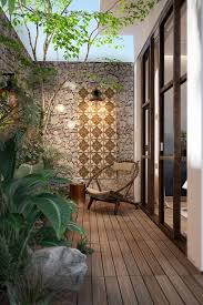 Stone And Tile Feature Wall Creates An Earthy Backdrop And N This Outdoor Area Small Backyard Garden Design Small Courtyard Gardens Backyard Garden Design