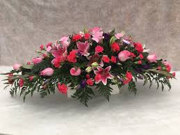 Classic circular funeral wreath based with white chrysanthemums. Coffin Sprays Funeral Tributes Casket Sprays Pink Sprays Funeral Flowers Peter Graves Florist Florists In Girton