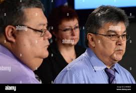 Chief Harry St. Denis of Wolf Lake, right, Chief Terrence McBride of  Timiskaming, left, and Chief Madeleine Paul of Eagle Village hold a press  conference