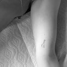 Minimalist Giraffe Tattoo On The Left Inner Arm Giraffe Tattoos Tattoos Small Giraffe Tattoo