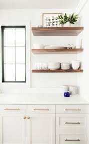 In this brownstone, floating shelves in an oak finish complement white shaker cabinets. Pin On Kitchens
