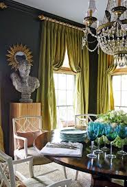 A white and blue abstract art piece hangs in a white and blue dining room from a wall clad in denim blue wallpaper and faces a white wooden dining table seating white and blue head chairs and round back blue dining chairs lit by a white ring. Sophisticated Redesign Interior Design Interior House And Home Magazine