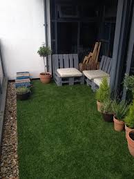 Artificial Grass Pallet Chairs On Balcony We Love This Trendy Look Small Balcony Garden Artificial Plants Balcony Design