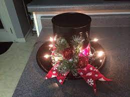 Snowman Hat Made From A Coffee Can Painted Black A Black Charger Lights Greenery And Ribbon Christmas Diy Christmas Crafts Xmas Crafts