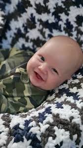 I finished the baby blanket I was crocheting that I posted about yesterday  for my son. He is in love with it and has not let me take it away from him