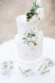 For a simple white wedding i used white swiss meringue buttercream to cover the two tiers of this elegant wedding cake and then decorated it with a flower arrangement. Simple Elegant White Wedding Cakes