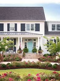 We personally love a black front door with large panes of glass and wood shutters. Tobi Fairley Interior Design White House Exterior Colors Exterior House Colors White Exterior Houses