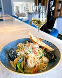 Our new lunch feature is a must try at your next visit! Seafood linguini  with white wine cream sauce, scallops, mussels, shrimp, heirloom cherry  tomatoes, arugula and Grana Padano! Available Wednesday to