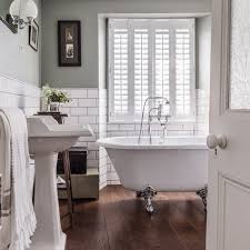 Crisp whites mingle with darkly stained wood to create contrast and make the room feel more open. Traditional Bathroom Pictures Ideal Home