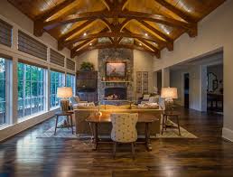 A circular brick pattern adds to the wagon wheel effect of the ceiling beams. Great Room Ideas Timber Frame Great Room