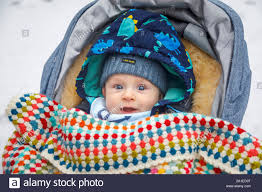 Ein Kaukasischer Baby Zwischen 4 Und 5 Monate Alt Mit Blauen Augen Im Kinderwagen Im Winter Durch Eine Gehakelte Decke Tragen Einer Schirmmutze Abgedeckt Im Alter Von Stockfotografie Alamy