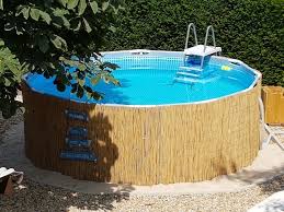 Cladding The Frame Pool With Bamboo Mats Is Easy And Looks Much Nicer Bamboo Cladd In 2020 Swimming Pools Backyard Above Ground Pool Landscaping Above Ground Pool
