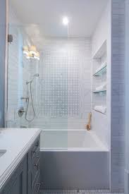 Marble master bathroom with three different sizes of marble carrara marble this is part 4 detailing the steps taken to installing the marble tile in the. Behind A Glass Partition A Drop In Tub Is Positioned Beneath Tiled Niche Shelves Framed By Marble Subway Bathroom Remodel Shower Bathroom Design Bathtub Tile