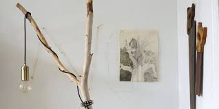 We have this very annoying tree right outside our apartment that blocks all light from our windows, thwarting the sun's attempts to warm us with its golden rays of energy. One Of A Kind Style A Diy Tree Branch Floor Lamp Apartment Therapy