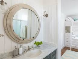 Bathroom mirrors can be round, oval, shaped as perfect circles, or rectangular, small, medium or large, to furnish the wall above the washbasin. This Mirror And Flanking Sconces Were Great Finds For This Bathroom Cabinetsanddesigns Net Bathroom Sconces