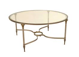 With a strong metal frame and distressed top, this round coffee table has a simple style that looks great in most settings. Modern Round Metal And Glass Coffee Table 1