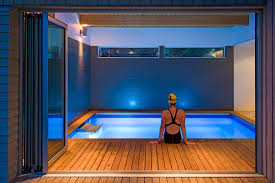With A Curtain To Draw Back And Ambient Lighting This Endless Pool Delivers Drama And Excitement Small Indoor Pool Indoor Pool Design Indoor Swimming Pools