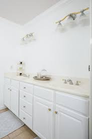 White painted trim travertine mirror mosaic tile toilet limestone floor chrome tubular sconces pedestal. How To Paint Your Bathroom Vanity Hgtv