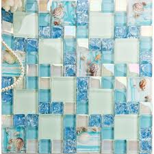 A single sheet of glass, painted blue on the back, gives this kitchen a clean and contemporary look. Cracked Blue Glass Mosaic Mediterranean Style Resin With Conch Shell Beach Inspired Backsplash Iridescent White Tile