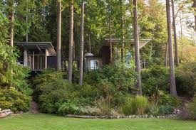 Open, the shutter decks are outdoor living space, connecting to the cabin's interior through tall. Olson Kundig Cabin At Longbranch