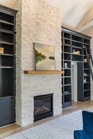 Crisp white finish, subtle woodwork and rustic white simulated stacked stone encases the firebox. Boral Winterhaven White Stone Fireplace Painting By Https Karenlane Typepad Com Natural Stone Fireplaces White Stone Fireplaces Stacked Stone Fireplaces