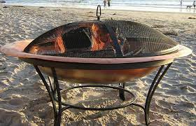 John timberland copper and black outdoor fire pit round 30 steel wood burning with spark screen and fire poker for backyard patio camping. 10 Best Copper Fire Pits For Your Outdoor Space 2021 Reviews