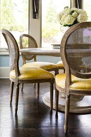 Get 5% in rewards with club o! Round Marble Top Dining Table With Round Cane Back Chairs And Yellow Seat Cushions Transitional Dining Room