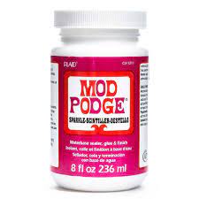 The puzzle sat on our big farmhouse to get started, i slipped wax paper under the completed puzzle before gluing it together. Mod Podge Sparkle Hobby Lobby 771097
