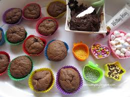Group of children baking cupcakes, squeezing cream from confectionery bag, preparing ingredients, topping, sprinkles for decorating cookies. Learn With Play At Home Decorating Cupcakes With Added Literacy Skills