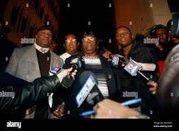 Edna Glover, center, mother of Henry Glover, who police were alleged to  have shot and later burned his body in a car in the aftermath of Hurricane  Katrina, talks to reporters with