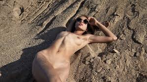 Girl in sand with sexy shaved armpits pics