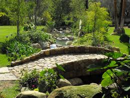 Or combine the two with a waterfall into your pool. Stone Bridge Over Man Made Creek Backyard Water Feature Pond Landscaping Ponds Backyard