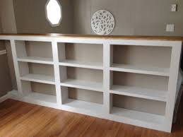 Before After A Genius Solution For An Awkward Staircase Bookcase Stairs Basement Built Ins Half Walls