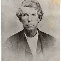 Edward Morris, three-quarter length portrait, full face, seated at desk]